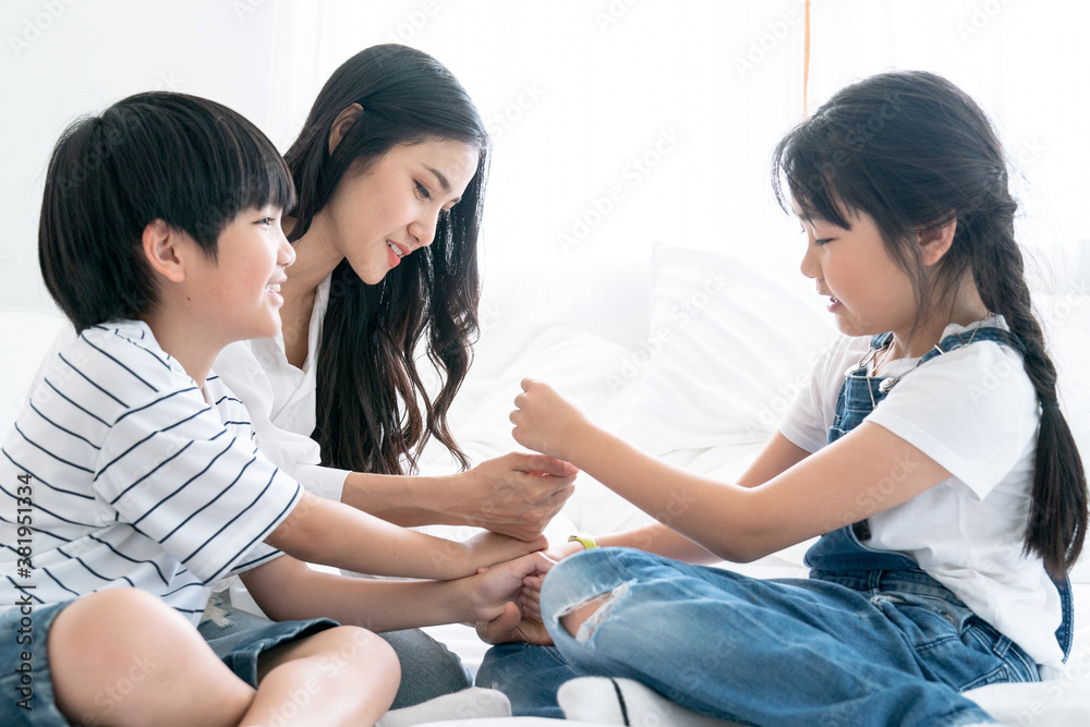 Asian mom playing with her son and daughter, They smile happily, Love, Family ties, Single Mother. Asian mom playing with her son and daughter, They smile happily, Love, Family ties, Single Mother.
