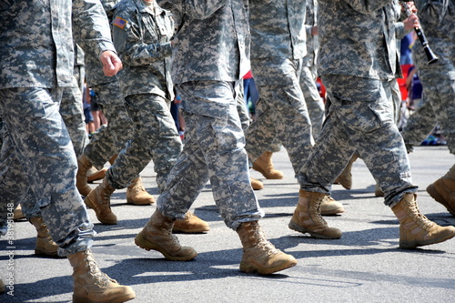 USA army marching band in a parade outdoors.