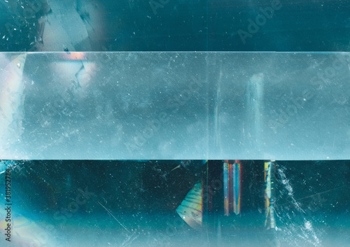 Ice abstract background. Frozen water texture. Teal blue scratched surface with copy space frame.