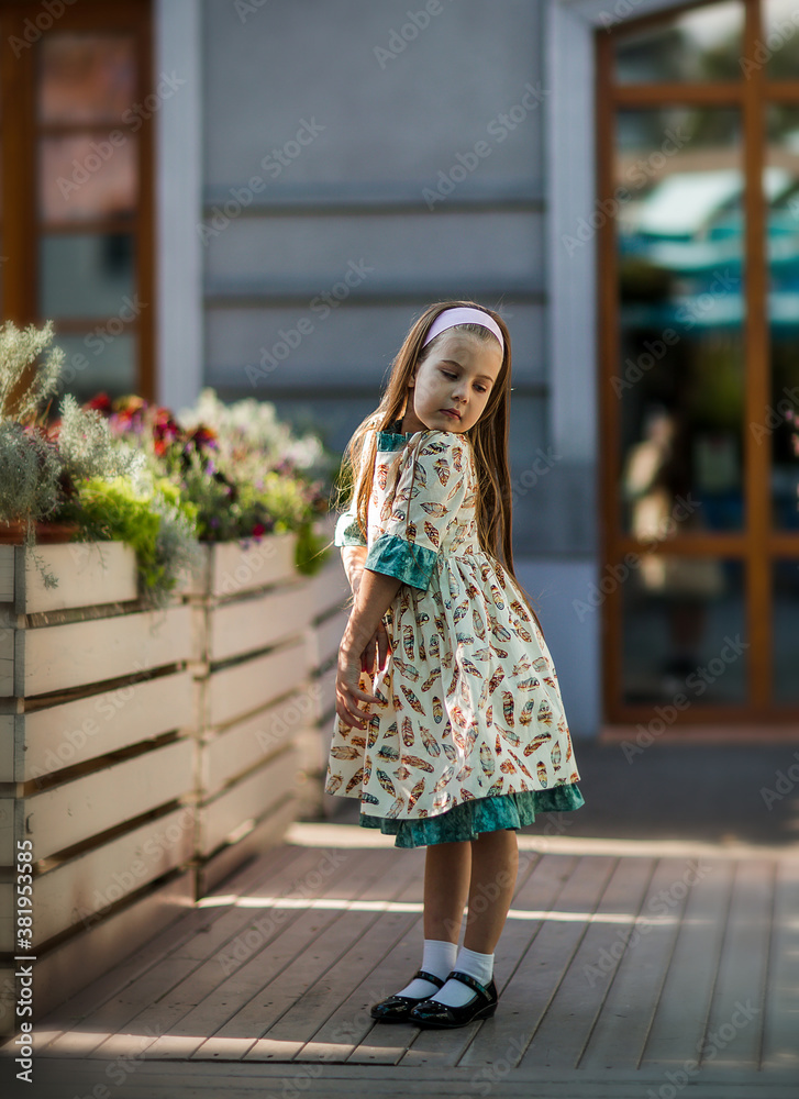 
little girl in an elegant dress grimaces