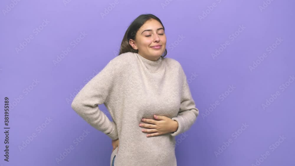 Young caucasian woman touches tummy, smiles gently, eating and satisfaction concept Young caucasian woman touches tummy, smiles gently, eating and satisfaction concept