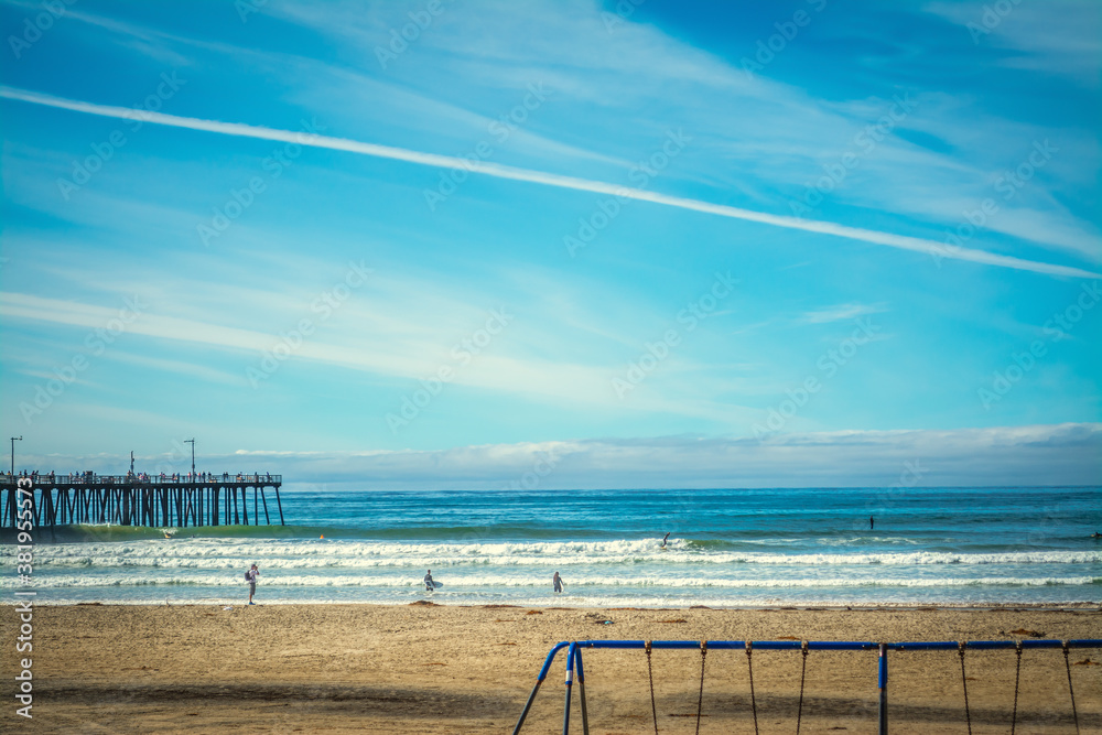 Surfers and photographer in Pismo Beach on a sunny day Surfers and photographer in Pismo Beach on a sunny day
