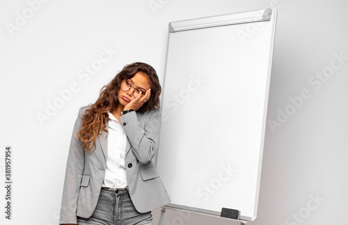 фотографія young businesswoman feeling bored, frustrated and sleepy after a tiresome, dull