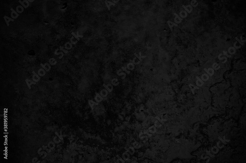 Black grunge stone background. Black concrete wall background. Macro. Dark cement texture.