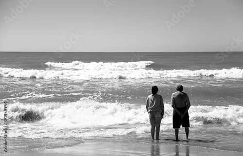 couple looking at the sea on the beach