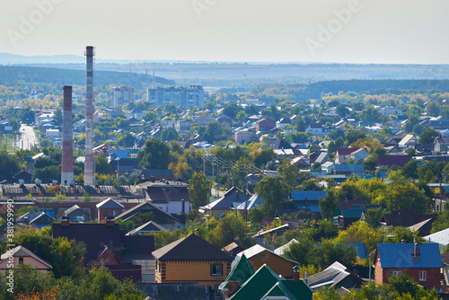 Small town with houses, factories and trees top view.