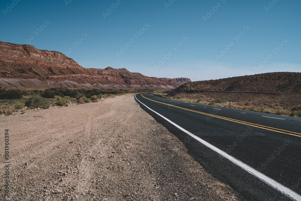 Empty asphalt road in dry valley in USA
