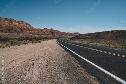 Empty asphalt road in dry valley in USA