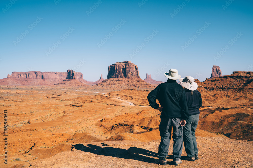 Unrecognizable couple looking at sandy terrain Unrecognizable couple looking at sandy terrain