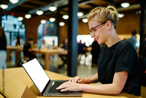 Busy freelancer using laptop in modern cafe