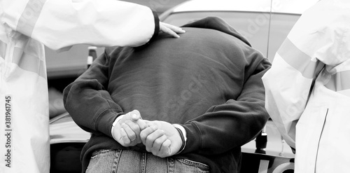 Man being arrested for drinking and driving, desaturated.