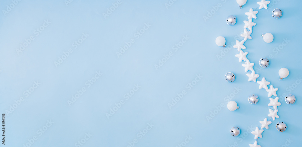 Flat lay border with christmas balls and stars on a blue background Flat lay border with christmas balls and stars on a blue background