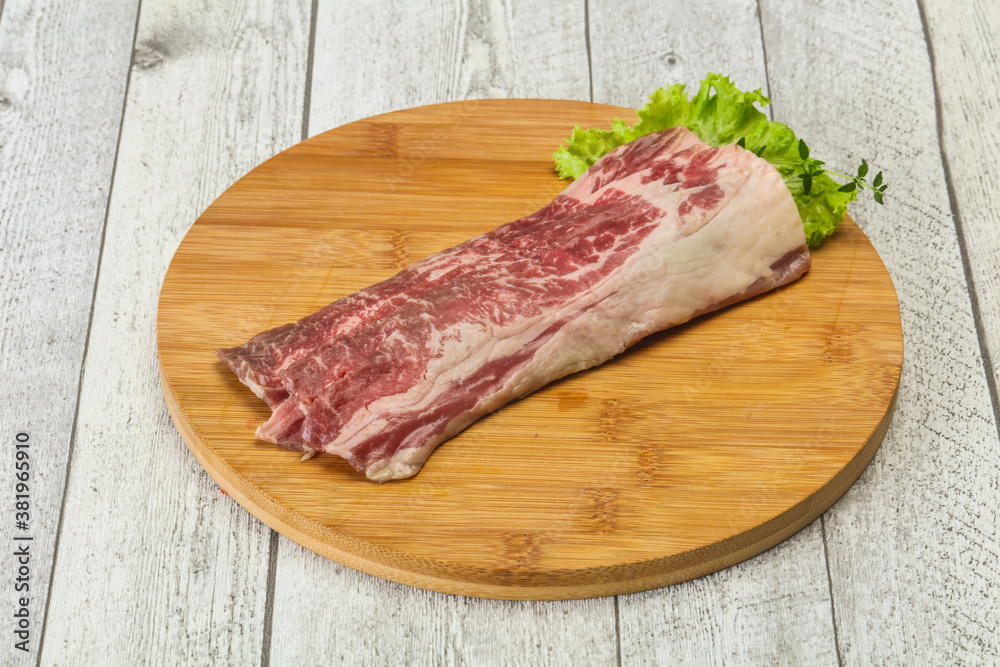 Raw beef bacon over wooden board Raw beef bacon over wooden board