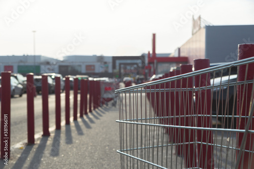 Metal supermarket trolley in the parking lot near the shopping mall © svitlini