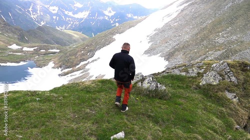 Successful man standing in the mountains, super slow motion