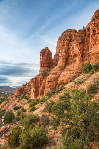 A formation of huge red sandstone rocks and juniper trees outside the city of Sedona, Arizona