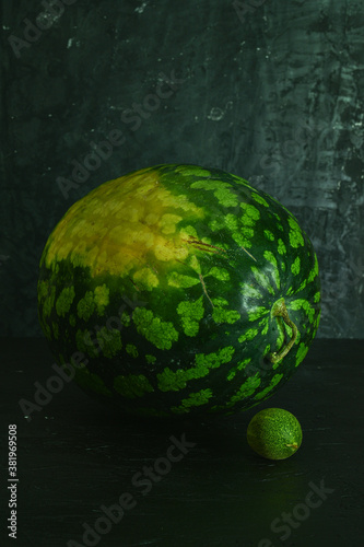 A whole big watermelon on a black table background