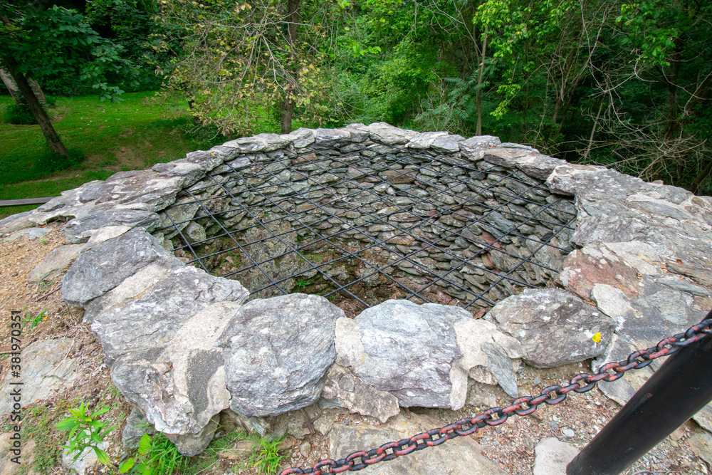A Large Cobblestone Hole With a Metal Covering Over the Top at the Historic Lock 12 In Pennsylvania