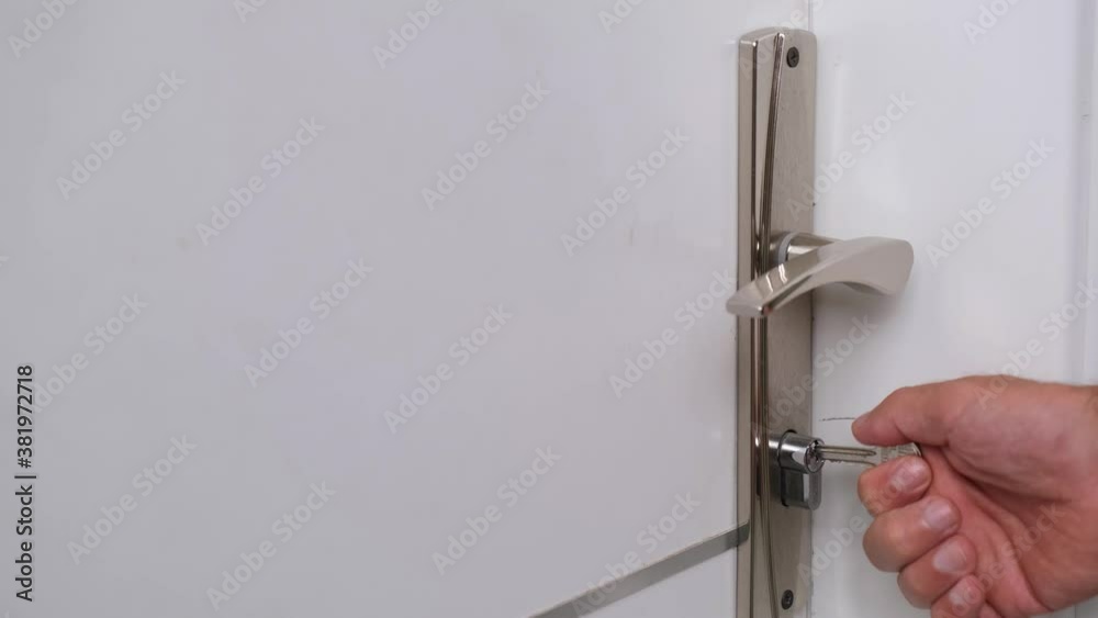 The man opens the door of the room with the key. The man opens the door of the room with the key.