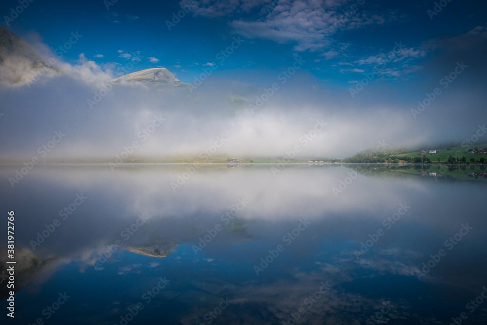 Obraz premium morning fog over the lake. Beautiful nature of Norway, fishing boats on the river