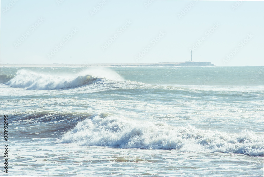 Waves crashing in front of a lighthouse in Western Sahara, Morocco, North Africa