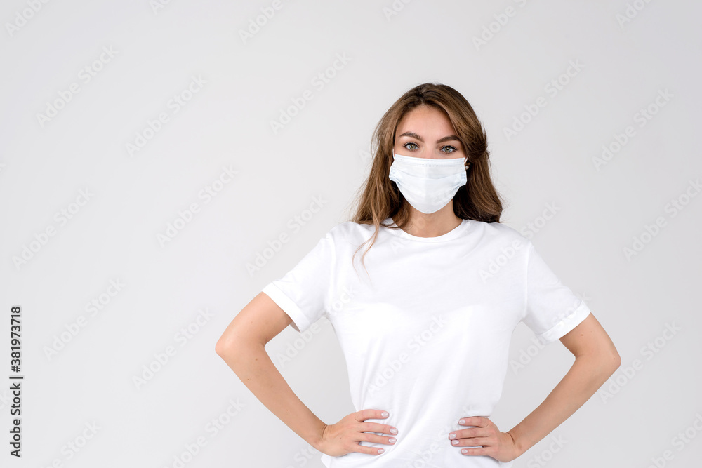 Flu concept. Beautiful woman with protective face mask, grey studio background Flu concept. Beautiful woman with protective face mask, grey studio background