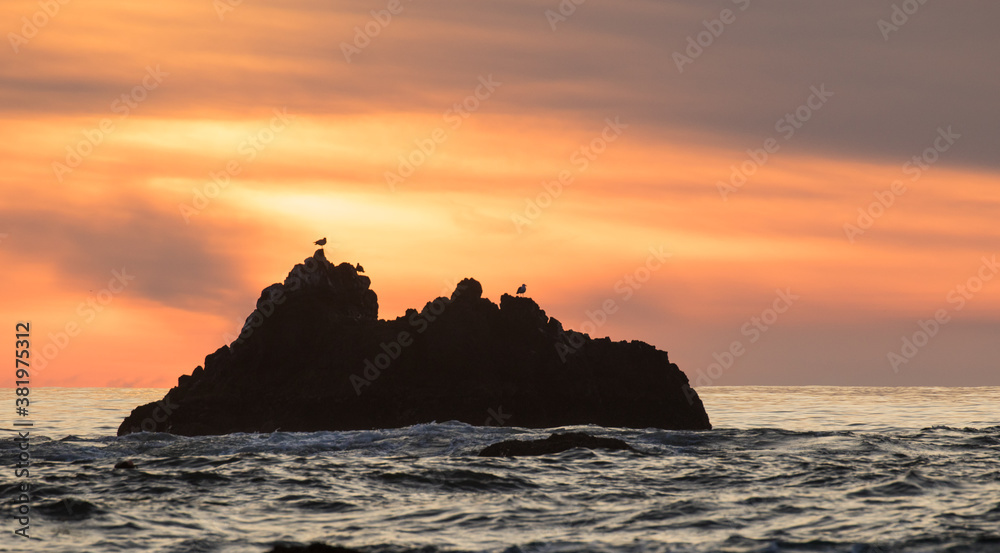 A rock outcropping at sunset, just off shore from the beach a Canon Beach on the north Oregon coast.