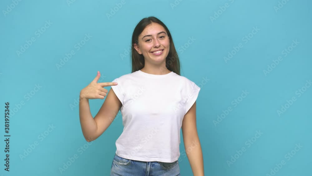 Young caucasian woman person pointing by hand to a shirt copy space, proud and confident Young caucasian woman person pointing by hand to a shirt copy space, proud and confident