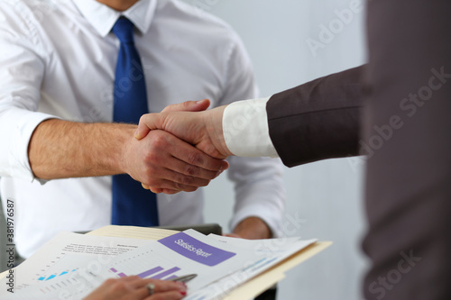 Man in suit and tie give hand as hello in office closeup. Friend welcome mediation offer positive introduction thanks gesture summit executive approval motivation male arm strike bargain