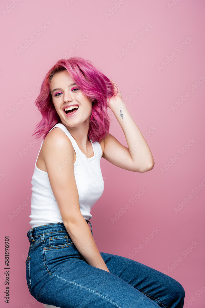 young woman with colorful hair and tattoo smiling isolated on pink young woman with colorful hair and tattoo smiling isolated on pink