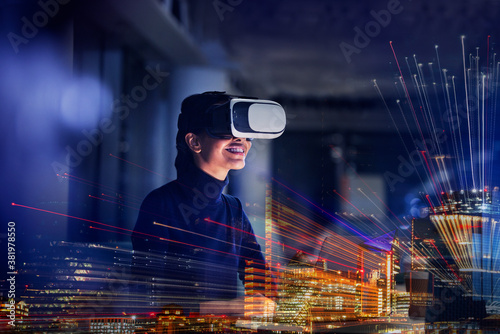 Smiling businesswoman using virtual reality glasses