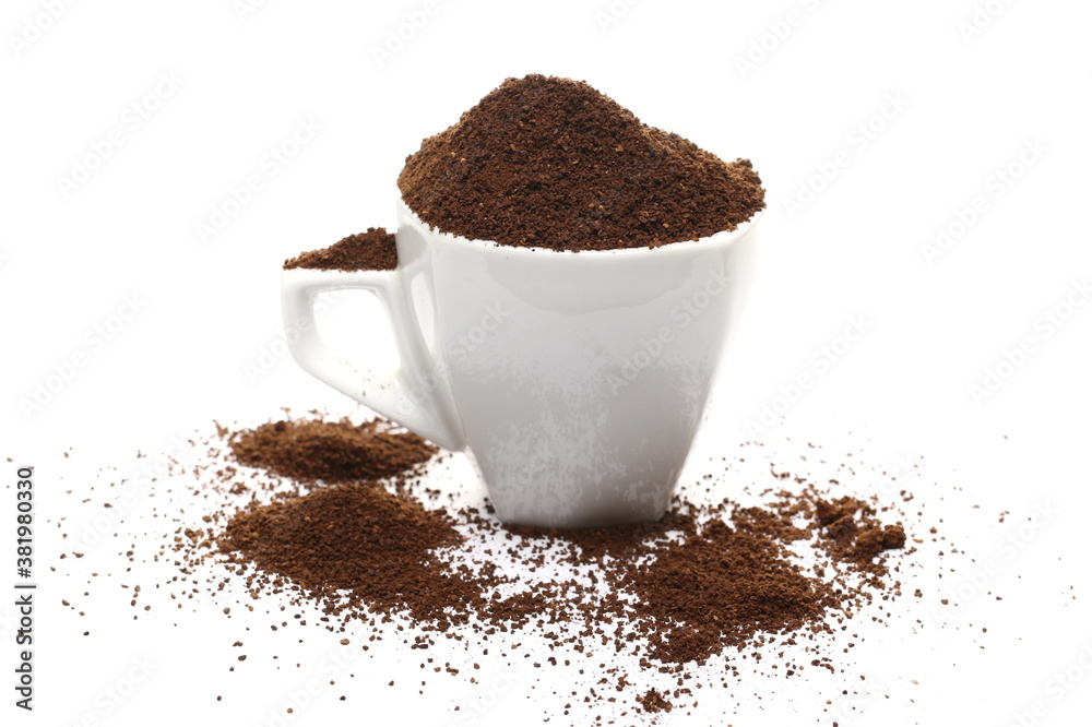 Pile of powdered, instant coffee and porcelain cup isolated on white background Pile of powdered, instant coffee and porcelain cup isolated on white background