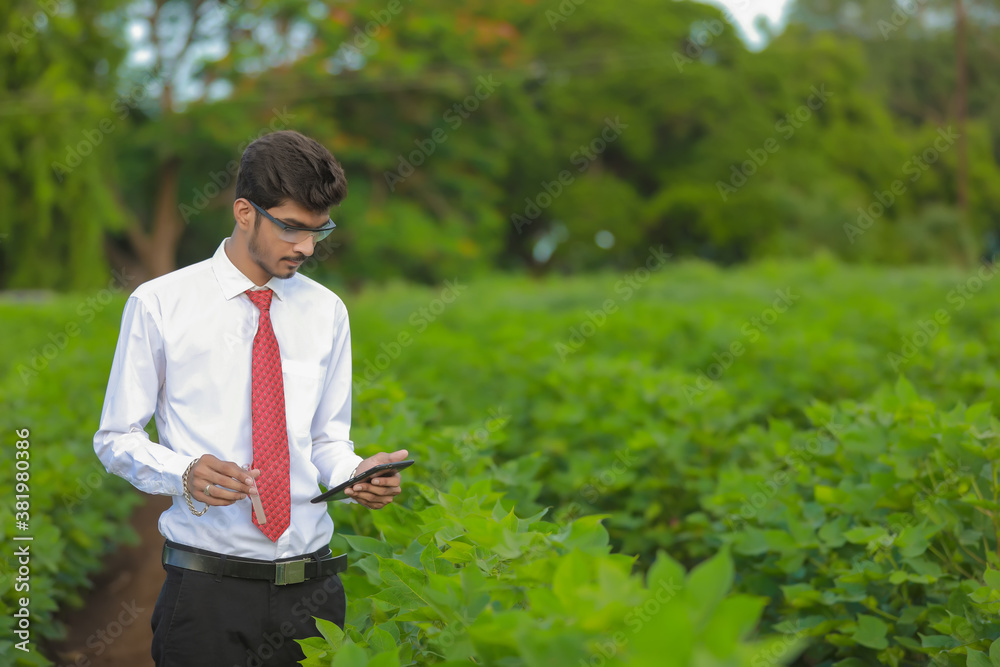 young indian handsome agronomist with test tube and tablet young indian handsome agronomist with test tube and tablet