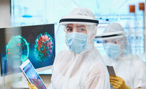 Portrait confident female scientist researching coronavirus photo