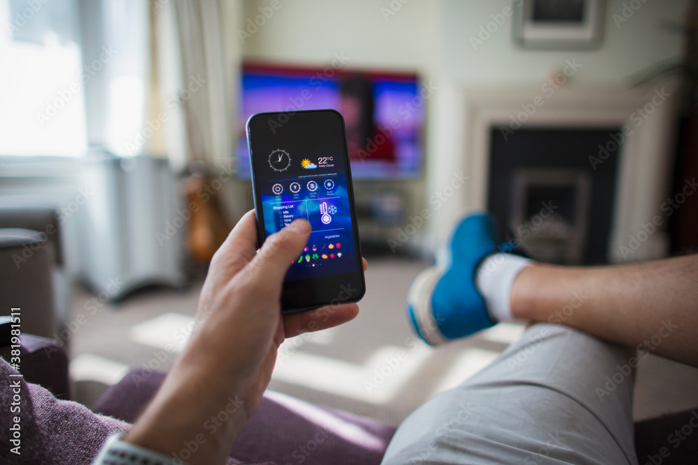 POV Man adjust temperature control on smart phone in living room POV Man adjust temperature control on smart phone in living room