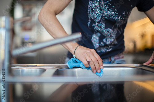 Close up woman disinfecting sink