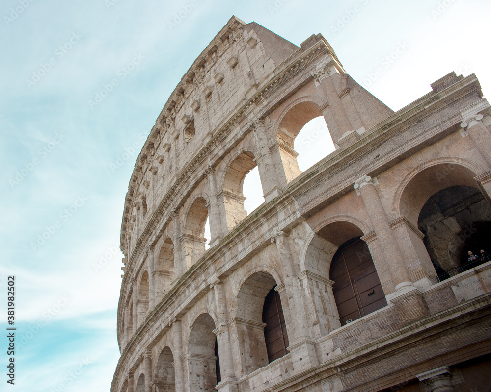 Facade of the Roman Coliseum with blue sky in the background