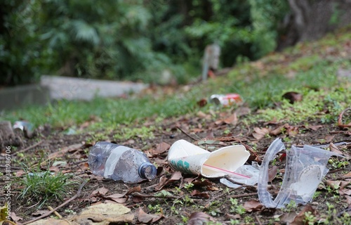 Garbage or litter food containers spread in the park polluting the environment and deteriorating the climate. photo