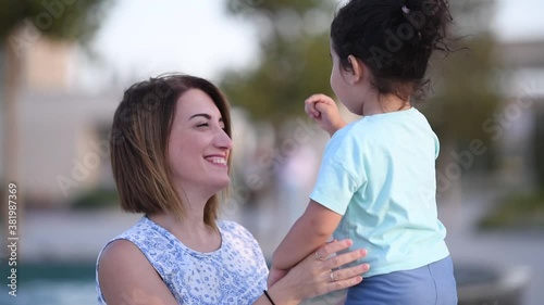 mom and daughter rub their noses photo