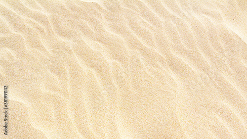 Rippled sand on the sea coast formed by wind and water, background, texture, pattern, banner