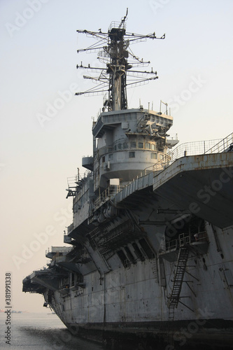 Shipbreaking Yard in Darukhana, Mumbai, India – INS Vikrant dismantling with scrap metal & workers in background