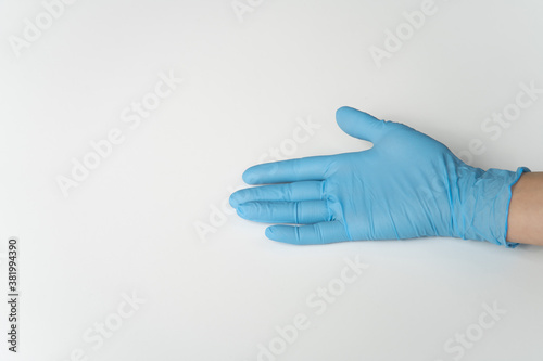 COVID, COVID-19 PPE Blue Latex Glove on Lady's Hand, On White Background