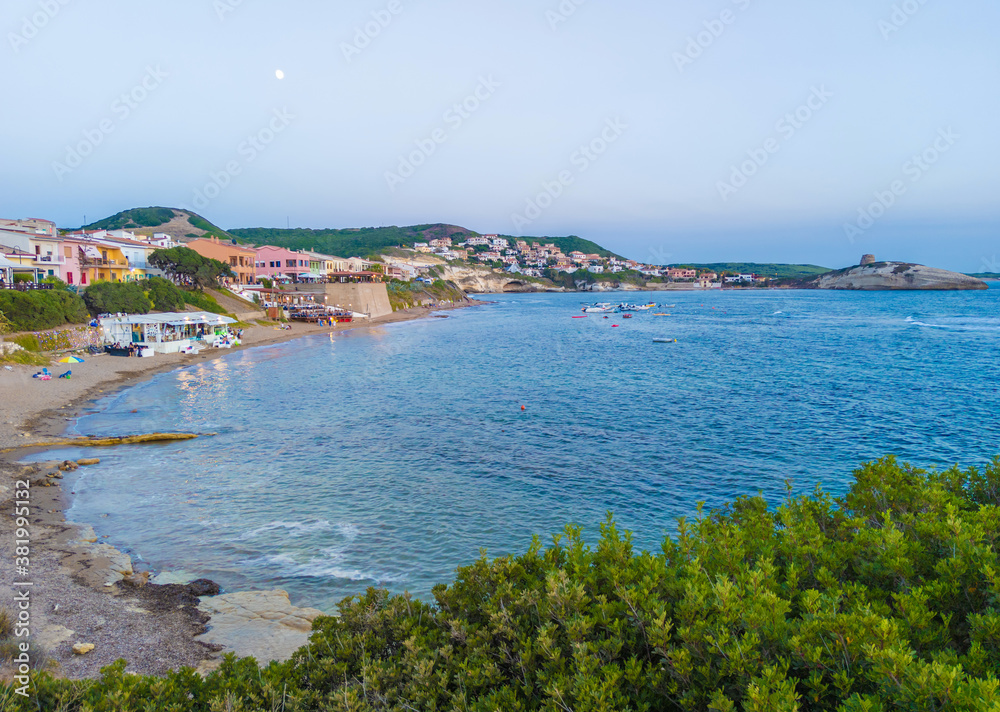 S'Archittu (Italy) - The little arch, in the Sardinian language, is a small coastal touristic town in province of Oristano, Sardinia region and island. Here a view at sunset.