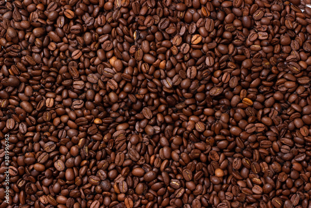 Background from coffee beans. Roasted coffee beans. Brown coffee beans in whole background. Background from coffee beans. Roasted coffee beans. Brown coffee beans in whole background.