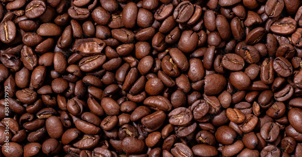 Background from coffee beans. Roasted coffee beans. Brown coffee beans in whole background. Background from coffee beans. Roasted coffee beans. Brown coffee beans in whole background.