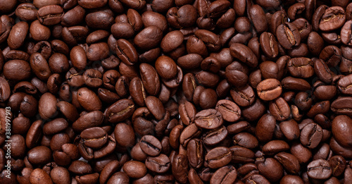 Background from coffee beans. Roasted coffee beans. Brown coffee beans in whole background.