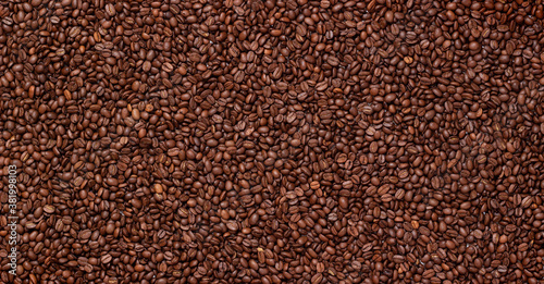 Grains coffee. Background from coffee beans. Roasted coffee beans. Brown coffee beans in whole background.