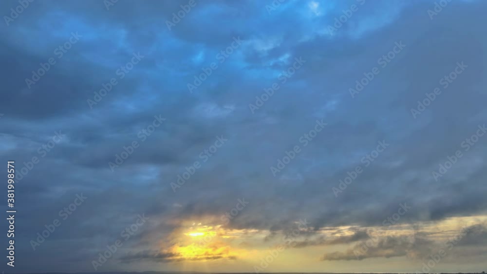 Bright panoramic sunrise sky and light of the sun white fluffy clouds in the blue sky view of timelapse Bright panoramic sunrise sky and light of the sun white fluffy clouds in the blue sky view of timelapse