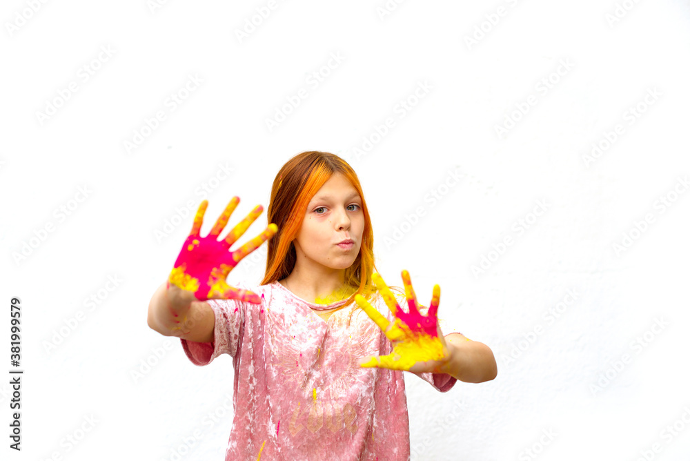 selective focus happy girl painted with Holi festival on white wall background selective focus happy girl painted with Holi festival on white wall background