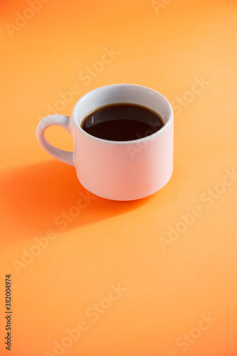 cup of coffee with orange background